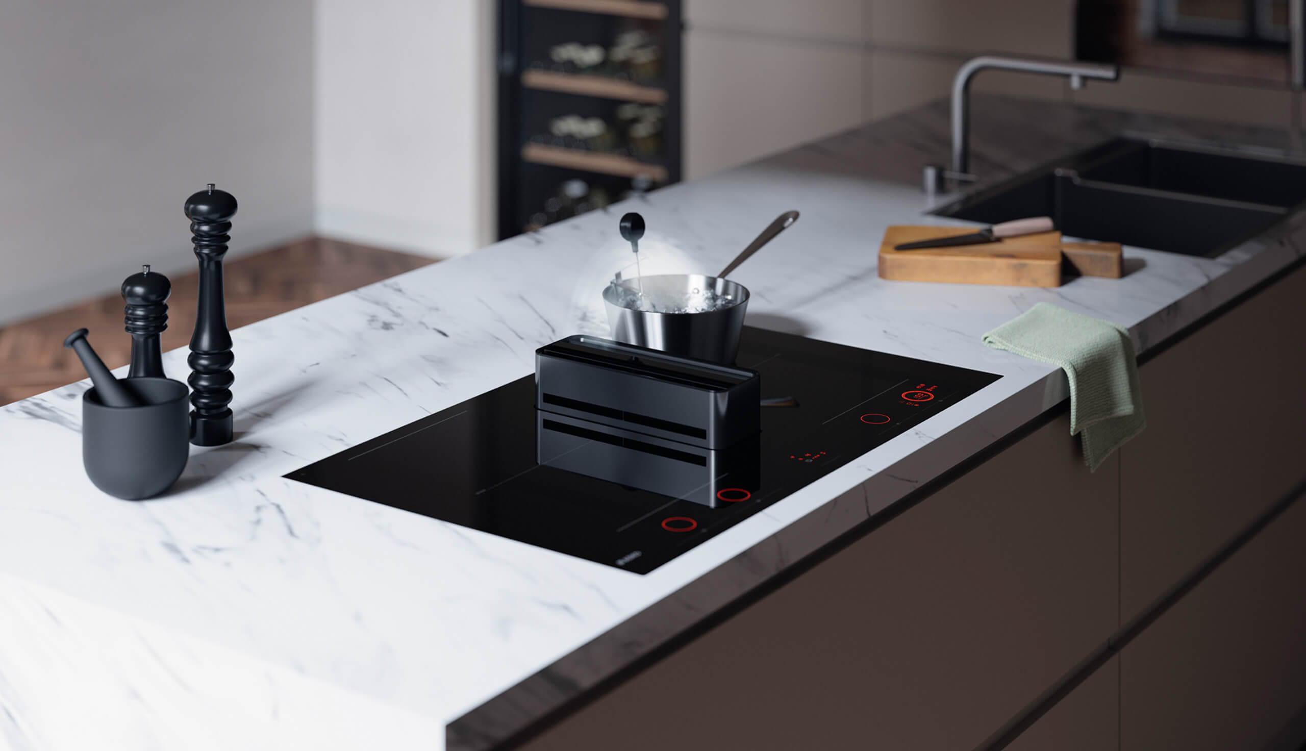 De ATAG Elevate inductiekookplaat met de gepatenteerde opstaande afzuigtoren in actie