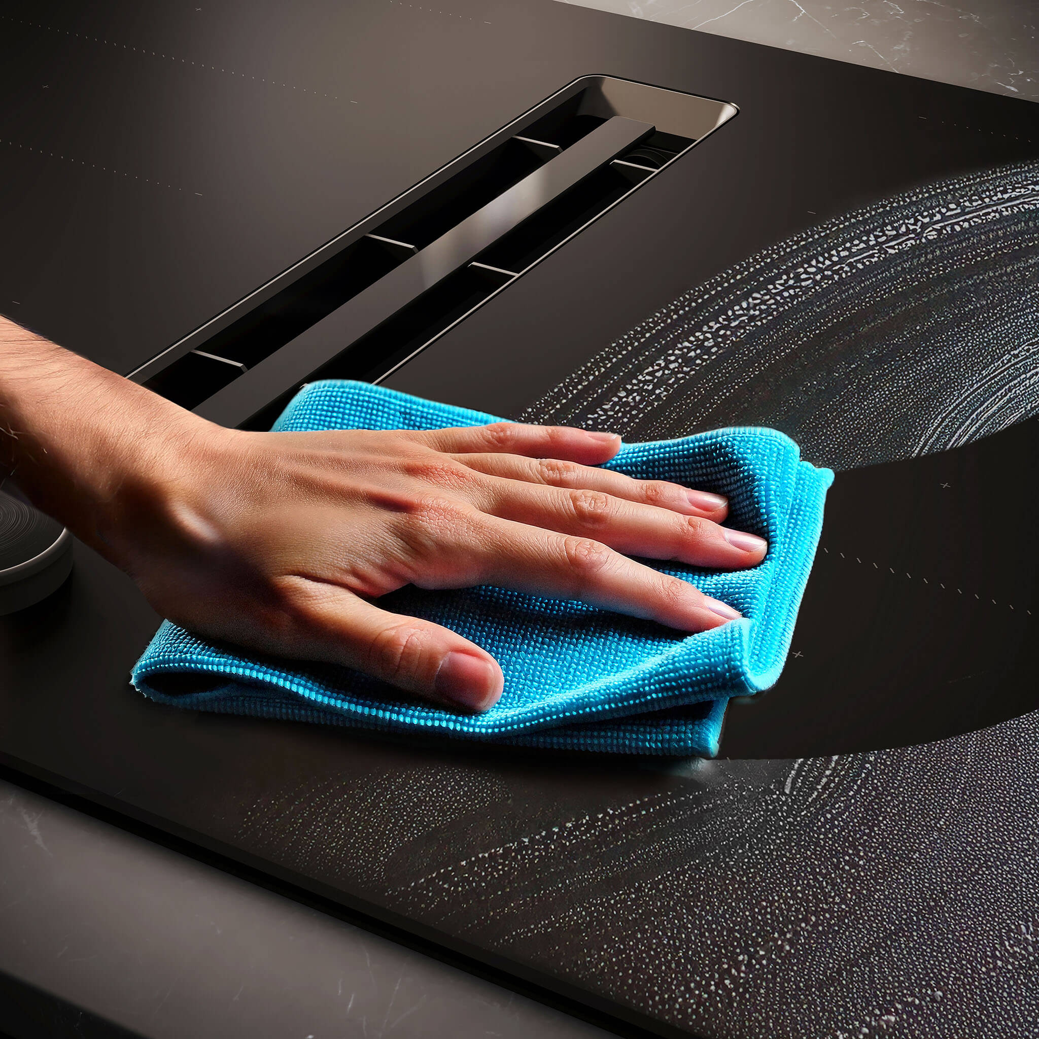 Detail van een matzwarte kookplaat van NEFF waarbij geen vingerafdrukken of strepen zichtbaar zijn.